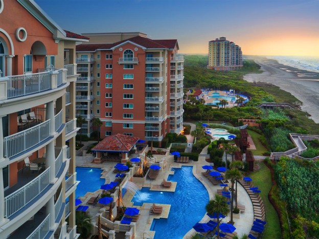 Aerial sunset view of Marriott's OceanWatch Villas, pools, and beach