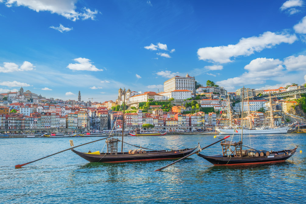 Traditional rabelo boats on the Douro River with Porto's skyline